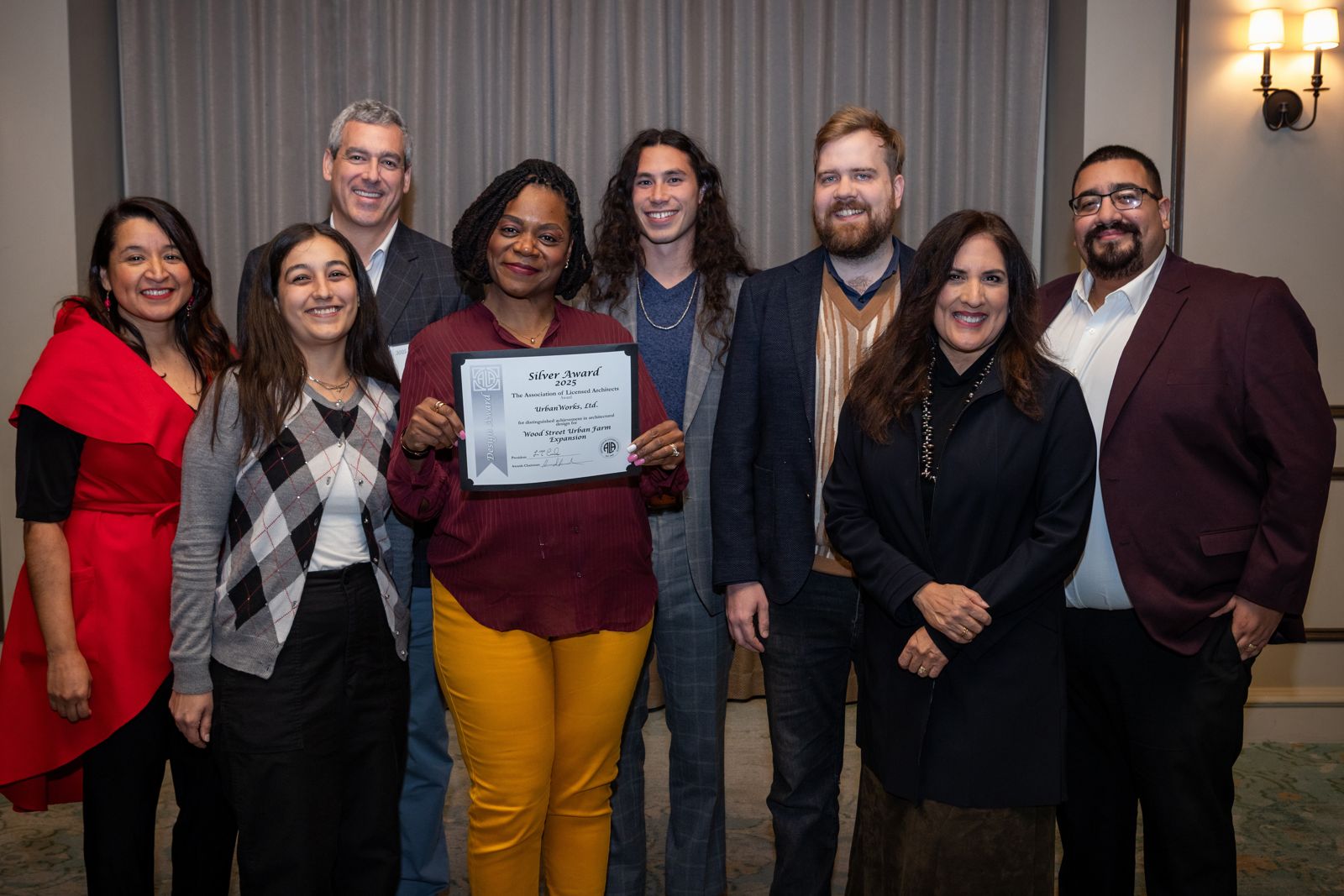 A 2025 winning project team with their award.