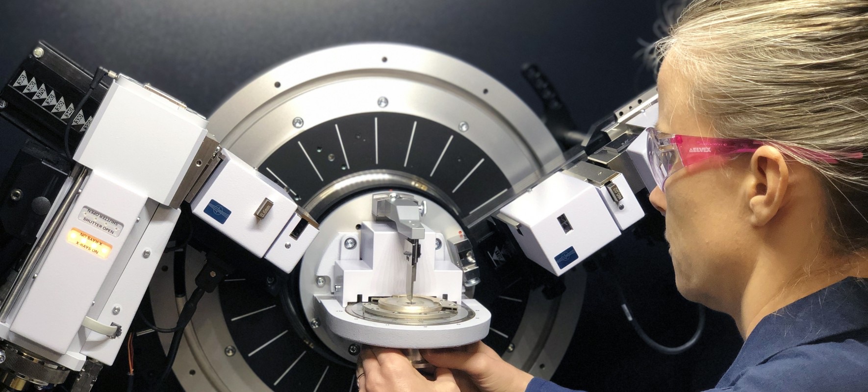A WJE scientist loads a sample into the X-ray diffraction instrument at the Janney Technical Center. Photo courtesy of WJE.