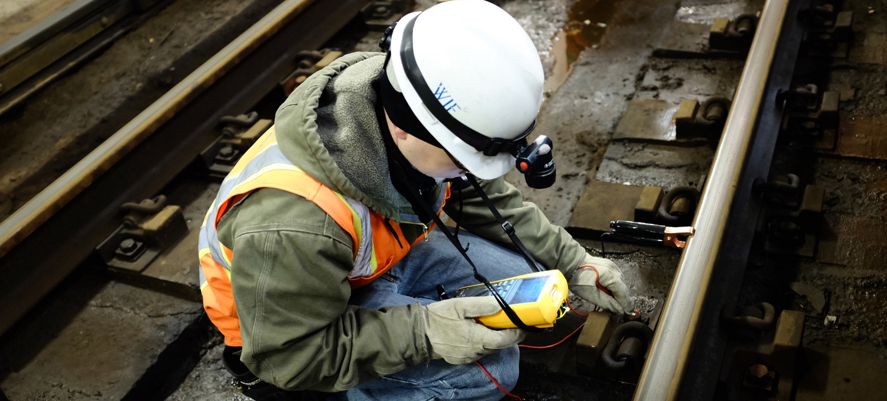 A WJE engineer takes nondestructive readings on a rail line. Photo courtesy of WJE.